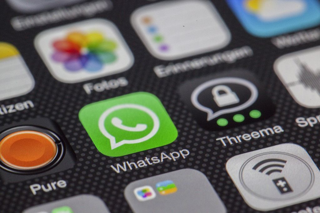 Detailed macro of smartphone screen showcasing popular app icons like WhatsApp.